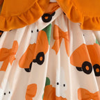 15 — Détail imprimé carottes nœuds orange, jupe plissée