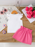 💐 Vue complète de l'ensemble à plat - haut avec appliqué floral et jupe parfaitement coordonnés pour un look harmonieux et raffiné