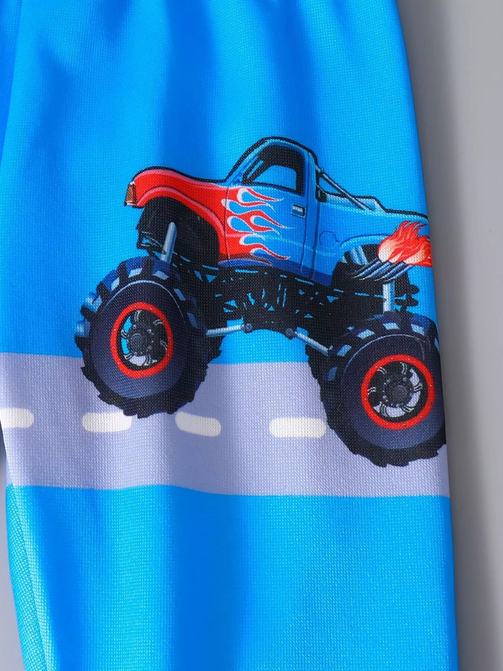Détail motif camion cartoon sur hoodie enfant - design coloré et amusant - BabyCoton Suisse
