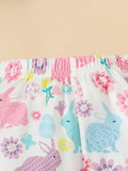 Pantalon évasé bébé fille lapins Pâques - blanc imprimé lapins colorés roses turquoise violets et fleurs printanières multicolores, taille élastique confortable - assorti body bleu ciel Happy Easter et bandeau fleuri - BabyCoton
